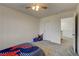A bedroom with gray carpet, a ceiling fan, and a window at 4240 Spring Storm Ave, North Las Vegas, NV 89081
