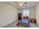 A bedroom with gray carpet, a ceiling fan, and a window at 4240 Spring Storm Ave, North Las Vegas, NV 89081