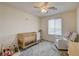 Bedroom with a crib, rocking chair, and soft gray carpet at 4240 Spring Storm Ave, North Las Vegas, NV 89081