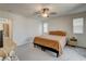 Cozy bedroom with soft neutral carpet, ceiling fan, and natural light at 4240 Spring Storm Ave, North Las Vegas, NV 89081