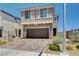 Two story home with a brick driveway, a two car garage and neutral colored stucco at 4240 Spring Storm Ave, North Las Vegas, NV 89081