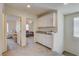 Bright hallway featuring white cabinets with granite countertops and open doorways at 4240 Spring Storm Ave, North Las Vegas, NV 89081