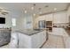 Gourmet kitchen island features granite countertops, a stainless sink, and ample cabinet space for storage at 4240 Spring Storm Ave, North Las Vegas, NV 89081