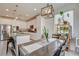 Bright kitchen with white cabinets, granite countertops, stainless steel appliances, and an adjacent dining area at 4240 Spring Storm Ave, North Las Vegas, NV 89081