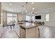 Open concept kitchen with granite counters and stainless appliances overlooks the living space at 4240 Spring Storm Ave, North Las Vegas, NV 89081
