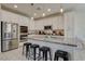 Modern kitchen with stainless appliances, granite counters, and a center island with bar stool seating at 4240 Spring Storm Ave, North Las Vegas, NV 89081