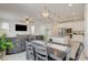 Open floor plan featuring a cozy living room and bright kitchen and dining area, perfect for entertaining at 4240 Spring Storm Ave, North Las Vegas, NV 89081
