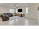 Bright living room features tile floors, a ceiling fan, and a wall-mounted television at 4240 Spring Storm Ave, North Las Vegas, NV 89081