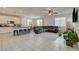 Open floor plan with large island, white cabinets, tile floor, and a gray couch at 4240 Spring Storm Ave, North Las Vegas, NV 89081