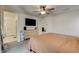 Comfortable bedroom features neutral carpet, dresser, ceiling fan, and easy access to the en-suite bathroom at 4240 Spring Storm Ave, North Las Vegas, NV 89081