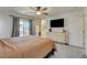 Spacious primary bedroom featuring neutral carpet, balcony access, a dresser, and an en-suite bathroom at 4240 Spring Storm Ave, North Las Vegas, NV 89081