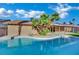 Backyard showcasing a sparkling pool and lush palm trees on a sunny day at 4637 Balfour Dr, Las Vegas, NV 89121