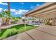 The backyard features a covered patio, turf lawn, and a sparkling pool at 4637 Balfour Dr, Las Vegas, NV 89121