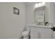 Elegant half bathroom featuring a modern vanity, stylish mirror and decor at 4637 Balfour Dr, Las Vegas, NV 89121
