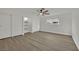 Bedroom featuring closet, ceiling fan, built-in shelves and wood-look flooring at 4637 Balfour Dr, Las Vegas, NV 89121