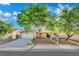 Charming single-story home with mature trees, a two-car garage, and a well-maintained front yard at 4637 Balfour Dr, Las Vegas, NV 89121