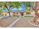 Charming home featuring a well-maintained front yard, mature trees, and inviting curb appeal at 4637 Balfour Dr, Las Vegas, NV 89121