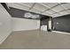 Spacious garage featuring black ceiling accents and a modern lighting fixture at 4637 Balfour Dr, Las Vegas, NV 89121