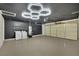 A well-lit garage features painted walls, epoxy flooring, and a modern lighting fixture at 4637 Balfour Dr, Las Vegas, NV 89121