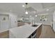 Open kitchen concept with a large island, stainless steel appliances, and modern lighting at 4637 Balfour Dr, Las Vegas, NV 89121