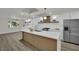 Bright kitchen features an island, stainless steel appliances, and white cabinetry at 4637 Balfour Dr, Las Vegas, NV 89121