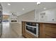 Island in the kitchen with stone countertops and stainless steel appliances, with an adjacent living space at 4637 Balfour Dr, Las Vegas, NV 89121