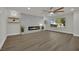 Bright and airy living room with a modern fireplace, wood-look floors, and ample natural light at 4637 Balfour Dr, Las Vegas, NV 89121