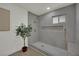 Modern walk-in shower featuring stylish tile and gold fixtures at 4637 Balfour Dr, Las Vegas, NV 89121