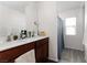 Bathroom featuring dual sinks with a dark wood vanity and shower with blue curtain at 4976 Quiet Morning St, Las Vegas, NV 89122