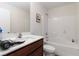 Bathroom featuring a tub, shower, and neutral countertop with a dark wood cabinet at 4976 Quiet Morning St, Las Vegas, NV 89122