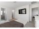Bright bedroom featuring wood-look floors, natural light, and a mounted TV for entertainment at 4976 Quiet Morning St, Las Vegas, NV 89122