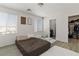 Comfortable bedroom with wood-look floors and natural light from the windows, offering a cozy retreat at 4976 Quiet Morning St, Las Vegas, NV 89122