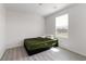 This bedroom is bright with wood-look floors and a large window, perfect for relaxing at 4976 Quiet Morning St, Las Vegas, NV 89122