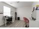 Bright bedroom features wood-look floors, desk with chair, and white walls perfect for a home office at 4976 Quiet Morning St, Las Vegas, NV 89122