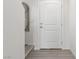 Bright entryway featuring a white front door, neutral paint, wood-look flooring, and large mirror at 4976 Quiet Morning St, Las Vegas, NV 89122