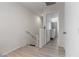 Hallway featuring safety gate at stairs, leading to bedrooms with ample lighting at 4976 Quiet Morning St, Las Vegas, NV 89122
