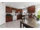Modern kitchen with ample dark wood cabinets and white appliances at 4976 Quiet Morning St, Las Vegas, NV 89122