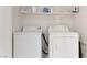 Practical laundry room featuring a side-by-side washer and dryer, with shelf at 4976 Quiet Morning St, Las Vegas, NV 89122