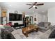 Comfortable living room with ceiling fan, neutral color palette, and entertainment center at 4976 Quiet Morning St, Las Vegas, NV 89122