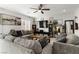Inviting living room with a ceiling fan, neutral paint, and comfortable seating area at 4976 Quiet Morning St, Las Vegas, NV 89122