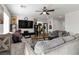Spacious living room with lots of comfy seating, natural light, and ceiling fan at 4976 Quiet Morning St, Las Vegas, NV 89122