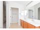 Well-lit bathroom featuring double sinks, white countertops, and a tiled floor, blending style and functionality at 5045 Bayberry Crest St, North Las Vegas, NV 89031