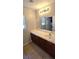 Bathroom vanity with a large mirror, abundant countertop space, and natural light, offering style and practicality at 5045 Bayberry Crest St, North Las Vegas, NV 89031