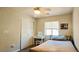 Bright bedroom features a ceiling fan, a window and a closet for storage at 5045 Bayberry Crest St, North Las Vegas, NV 89031