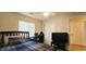 Comfortable bedroom featuring a dark wood bed frame, ceiling fan, and plenty of natural light from the window at 5045 Bayberry Crest St, North Las Vegas, NV 89031