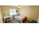 Comfortable bedroom features a ceiling fan, a window and a small desk at 5045 Bayberry Crest St, North Las Vegas, NV 89031