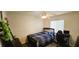 Bedroom with a ceiling fan, window, bed, desk, and modern décor at 5045 Bayberry Crest St, North Las Vegas, NV 89031