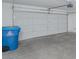 Spacious garage with ample room for parking, featuring a blue recycle bin at 5045 Bayberry Crest St, North Las Vegas, NV 89031