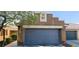 A well-maintained two-car garage complements the neutral stucco exterior for a clean and modern curb appeal at 5045 Bayberry Crest St, North Las Vegas, NV 89031