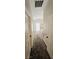 Hallway with carpet leading to a bedroom with ample natural light and neutral wall decor at 5045 Bayberry Crest St, North Las Vegas, NV 89031